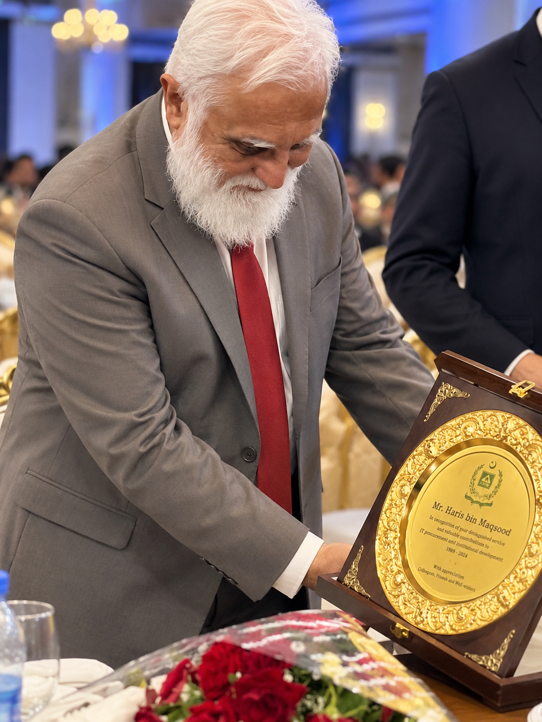Haris Bin Maqsood with a commemorative award plaque